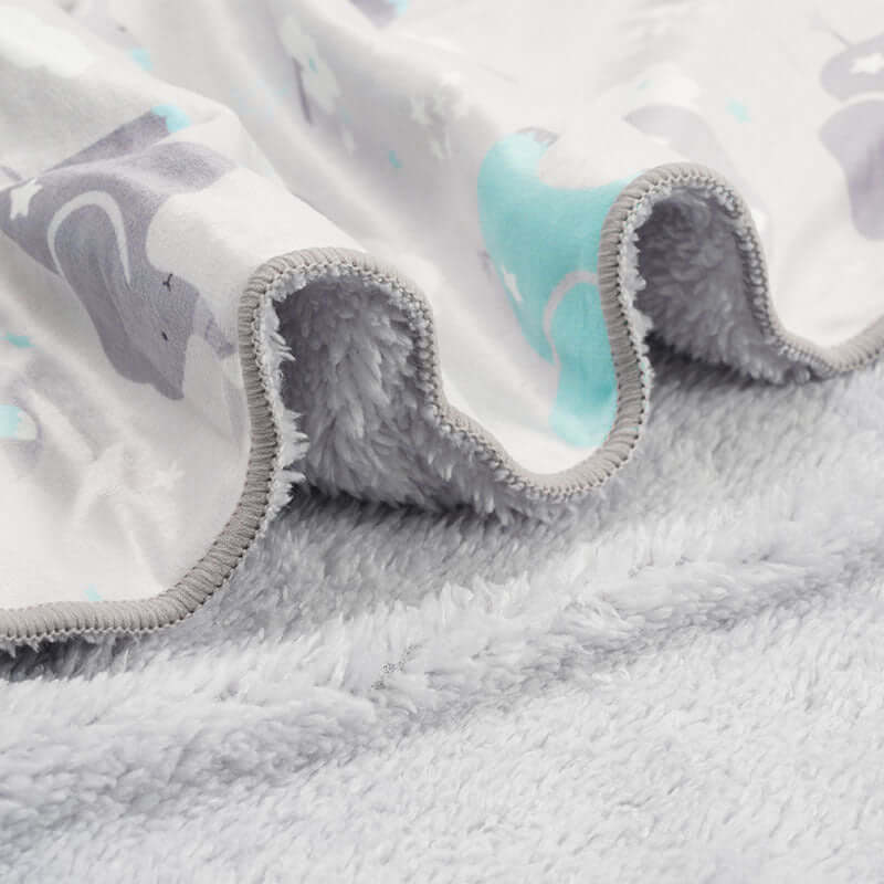 closeup of Ultra- soft plush baby blankets in different designs